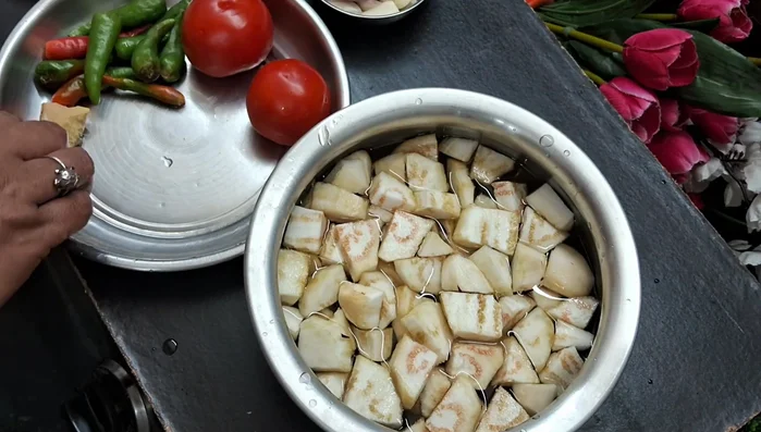 Make a paste of garlic, onion, tomatoes, green chilies, and ginger.