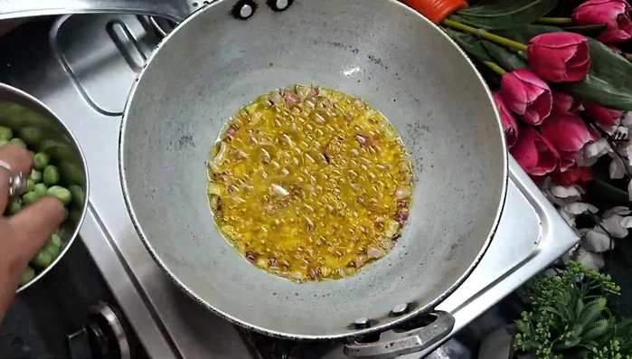 Add the brinjal pieces to the pan and fry lightly.