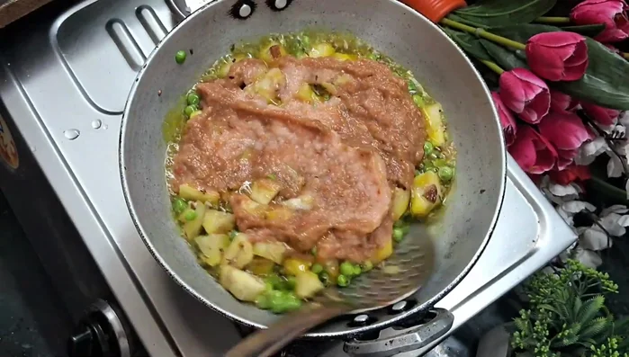 Add the prepared paste to the pan and fry well. Cover and cook for a few minutes.