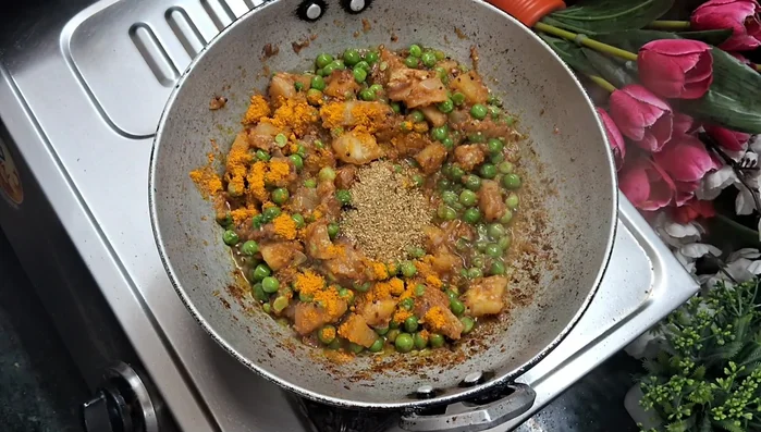 Add turmeric powder, coriander powder, red chili powder, garam masala, and vegetable masala. Mix well.