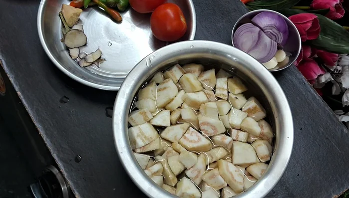 Add salt to the brinjal pieces in the water.