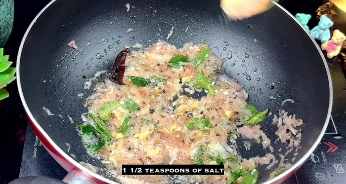 Add salt, turmeric powder, and chili powder. Stir well to coat the onions.