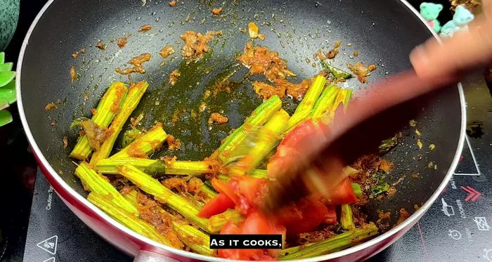 Add the chopped tomato. Cover and cook for another 5 minutes until soft.