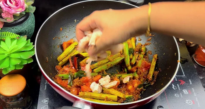 Add the prawns and chopped raw mango. Mix well.