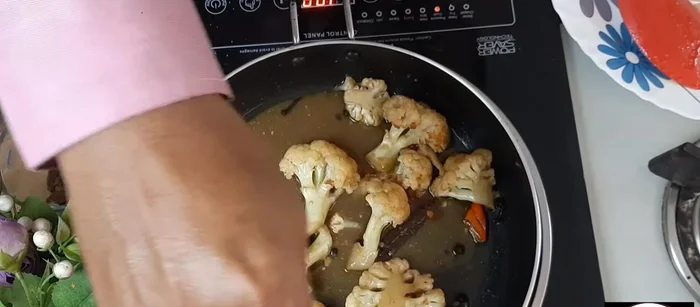 Let it boil again. Add a pinch of garam masala and stir.