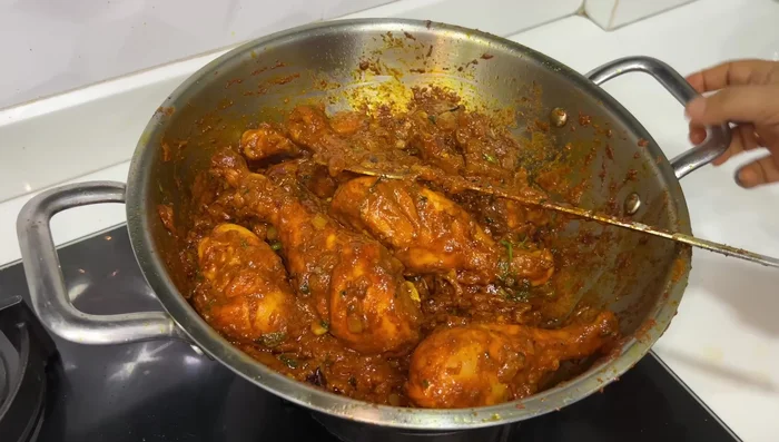 Cook the chicken: Fry the marinated chicken until well-cooked. Add water to create a light gravy.