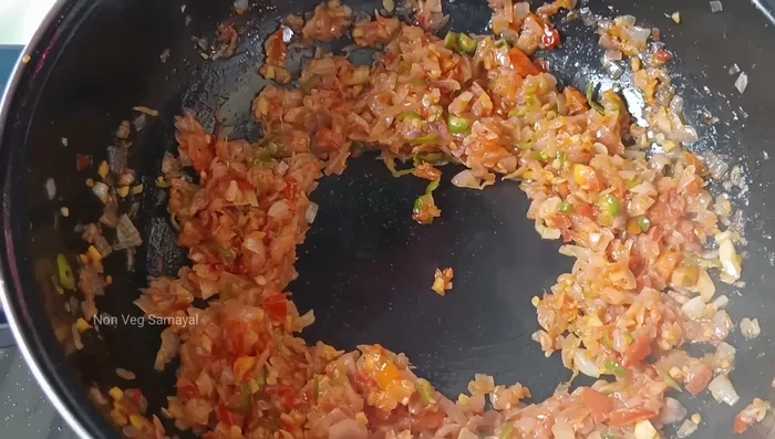 Pour the whisked egg mixture into the pan, over the onion and tomato mixture. Let it cook undisturbed for a minute.