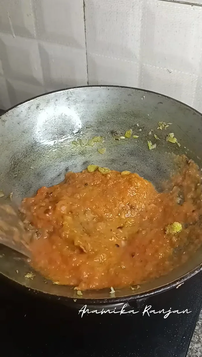 Cook the tomato puree until it reduces to half. Add ginger-garlic-green chili paste, salt, turmeric, and other spices (coriander, cumin, chicken/vegetable masala) to taste.