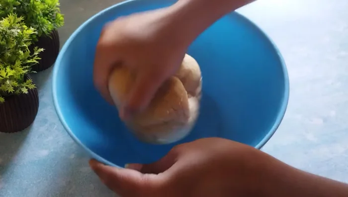 After resting, knead the dough again until smooth.