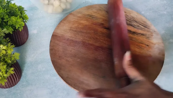 Roll each ball into a very thin circle. Make sure it's thin to ensure crispiness.
