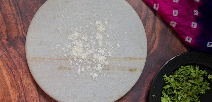 Sprinkle chopped coriander and nigella seeds on each rolled naan. Gently roll over with the rolling pin to adhere the toppings. (Optional: you can skip this for plain naan)