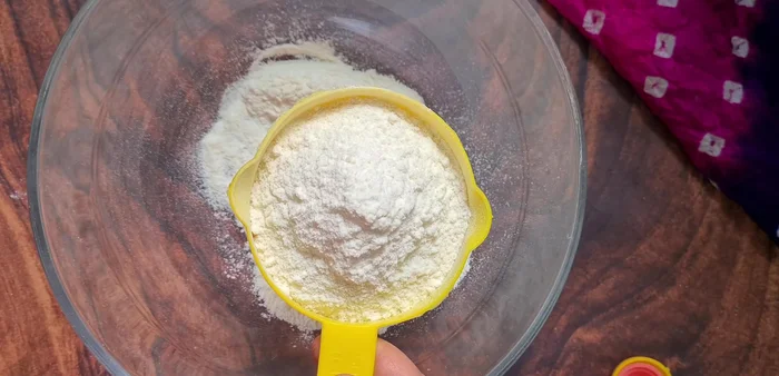 In a large mixing bowl, combine refined flour, salt, sugar, baking soda, and oil. (Avoid fragrant oils like mustard oil).