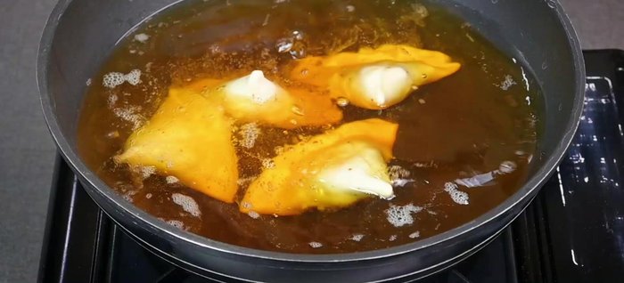 Heat oil in a pan over medium heat. Carefully add samosas to the oil, ensuring not to overcrowd the pan. Fry for 2-3 minutes without disturbing, then gently flip and continue frying until golden brown and crispy.