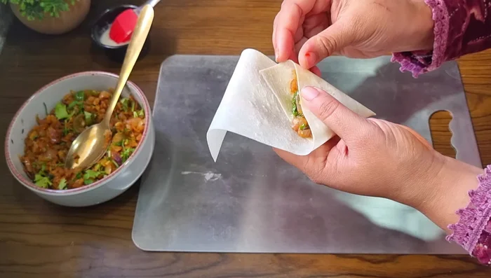 Seal the samosas by applying more flour paste and pressing the edges firmly.