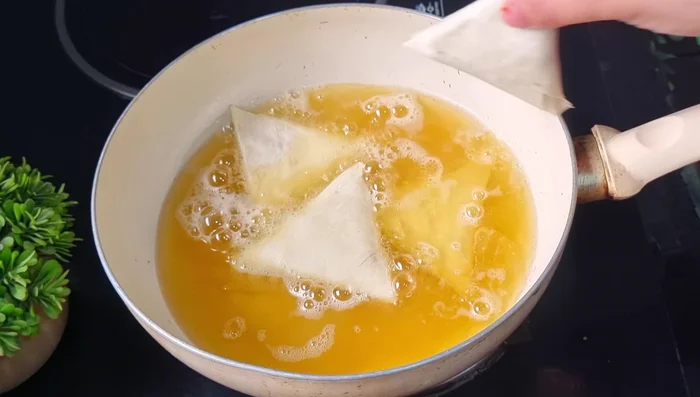 Fry samosas in medium-hot oil until light golden brown on both sides (approximately 1-1.5 minutes per side).