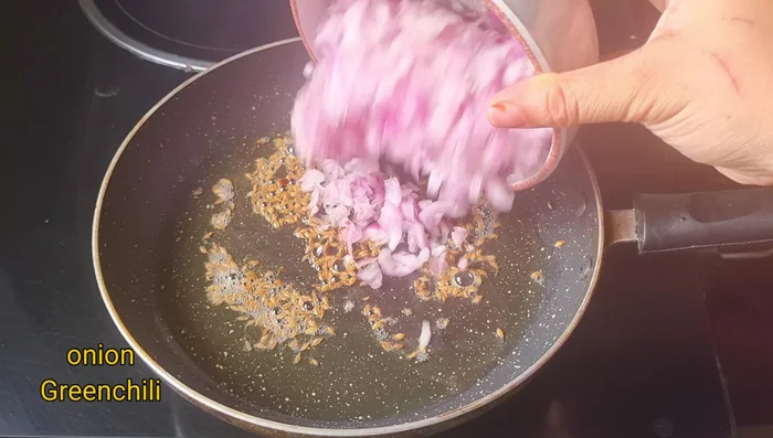 Add chopped onions and green chilies. Fry on low-medium flame for 2-3 minutes, until softened but still crunchy.