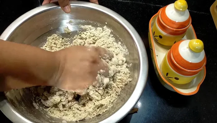 Gradually add water, mixing until a stiff dough forms. Continue mixing for about 5 minutes until the dough is well combined.