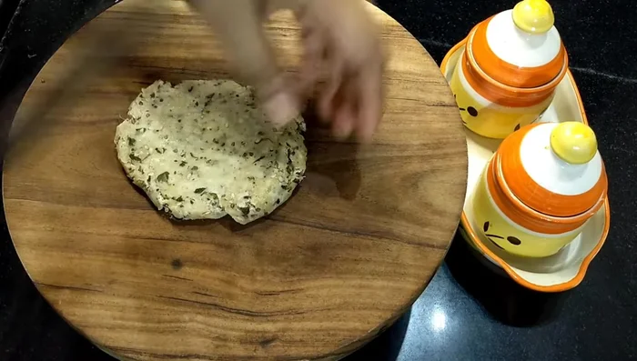 Make balls from the dough and roll them into thick rotis (not too thin).