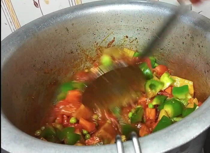 Add capsicum and fry for a few minutes. Stir in mint and coriander leaves.