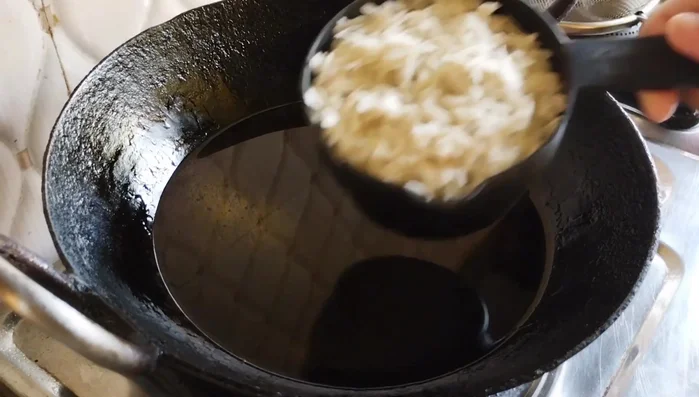 Heat oil in a wok until very hot (a piece of poha should immediately float). Fry the poha in batches until puffed and crispy. You can use a sieve to fry poha directly in oil for easier handling.