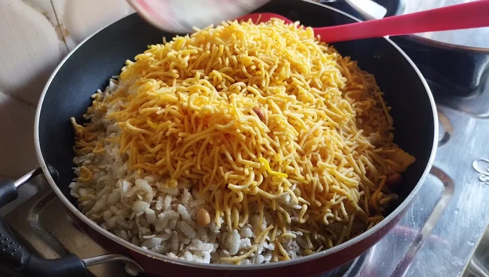 Add sev namkeen and mix well with turmeric.