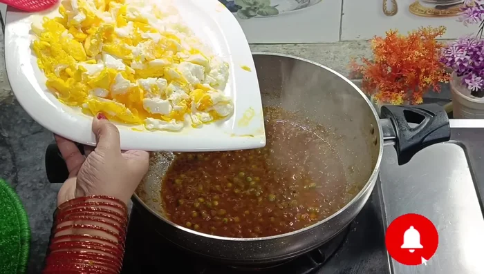 Add the chopped eggs to the pea curry.