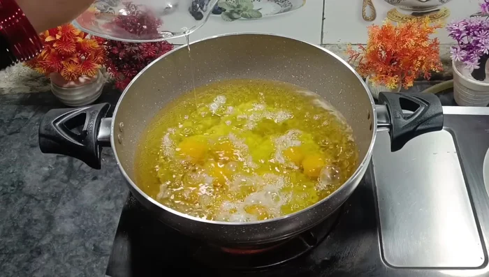 Add 6-7 eggs to the hot ghee/oil and cook gently without stirring, until cooked through. (This will be determined by visual signs of the egg being fully cooked)