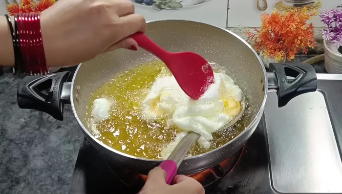 Remove eggs using a strainer to drain excess ghee/oil.