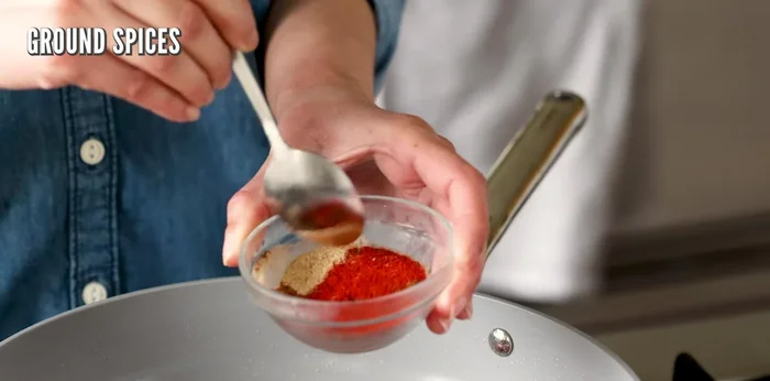In a small bowl, mix ground spices (recipe notes below). Add 2/3 of the mixture to the onions, add a splash of water to help blend and prevent burning.