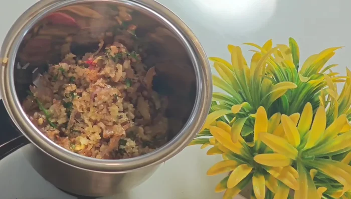 Grind the roasted mixture with tamarind, turmeric powder, and water into a fine paste.