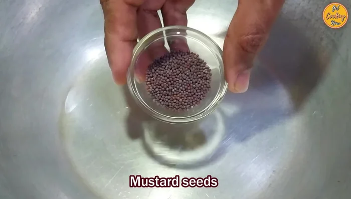 Prepare the Bhaji: Heat oil in a pan. Add mustard seeds, then cumin seeds, and asafoetida. Add onions and curry leaves, sauté until translucent. Add garlic and ginger, sauté until fragrant. Add green chilies and turmeric powder.