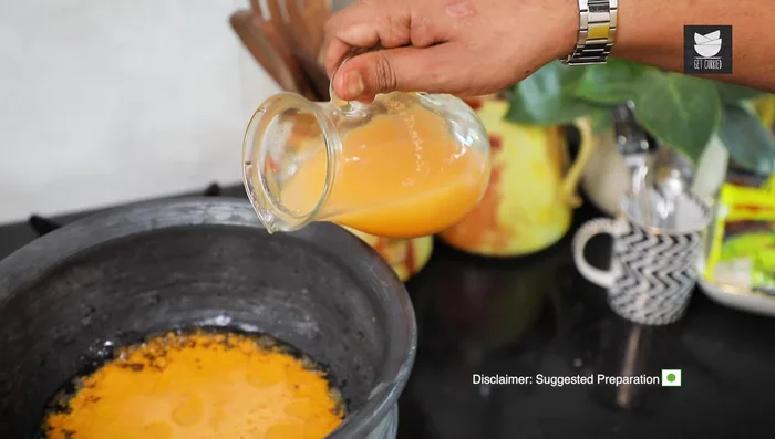 Add the prepared wet paste and water from the blender. Adjust water consistency as needed.