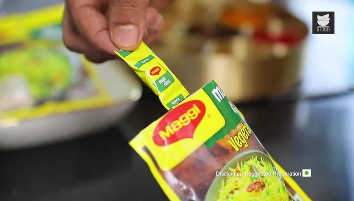 Add vegetarian Maggie Magic Cubes, crumbling them over the curry. Stir well.