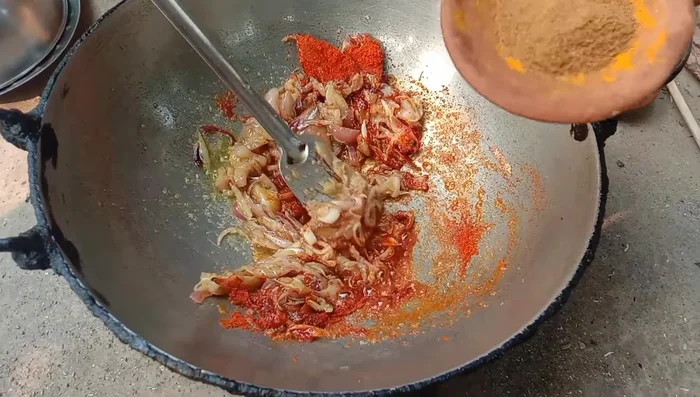 Add chili powder, cumin powder, and turmeric powder. Fry the spices briefly.
