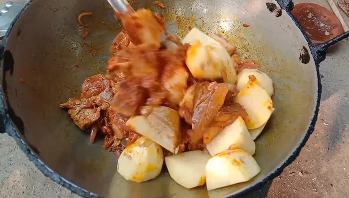 Add the pork, potatoes, and tomatoes. Stir well.