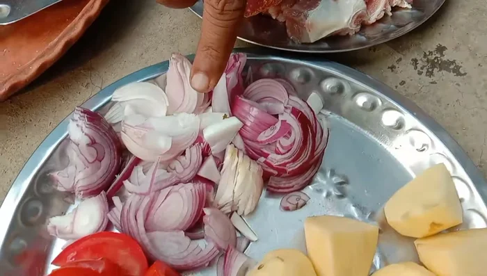 Chop onions, potatoes, and tomatoes.