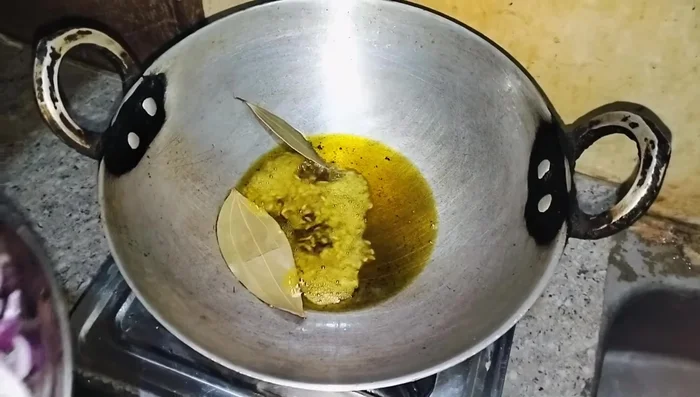 Add sliced onions and fry until brown.
