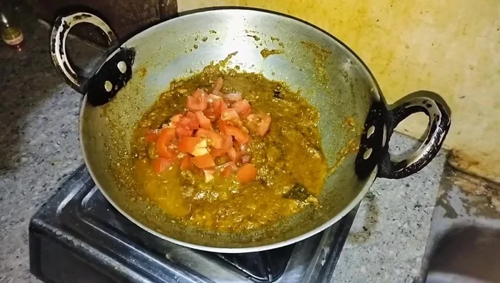 Add tomatoes, salt, and fry for 5 minutes until soft.