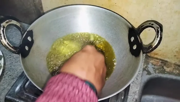 Fry the koftas until golden brown on both sides.