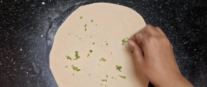 Roll up the chapati tightly, adding water to seal.