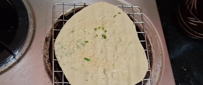 Preheat a tandoor pan or flat griddle on the stove over low heat. Cook the rolled chapati for a couple of minutes on each side until lightly browned. Apply a little butter or oil while cooking.