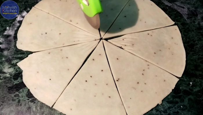 Cut each roti into 8 equal parts, make cuts on the ends. Place stuffing on one side, apply slurry on the ends, fold into triangles and seal.