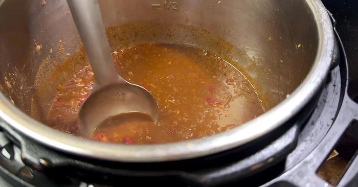 Slightly mash the rajma for a thicker gravy. Add kasuri methi.