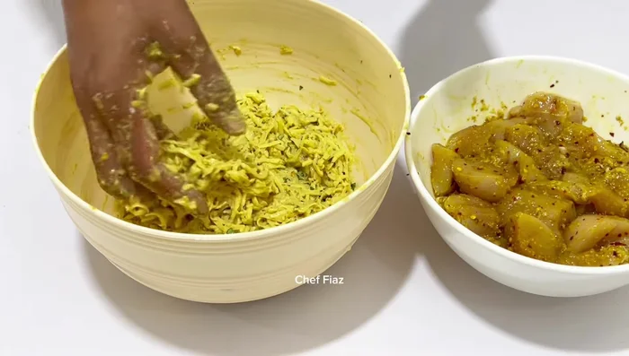 Take a piece of marinated chicken and wrap it with the potato mixture to form a pakora. (368.88)