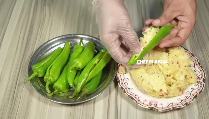 Fill the chillies with the potato and cheese mixture.
