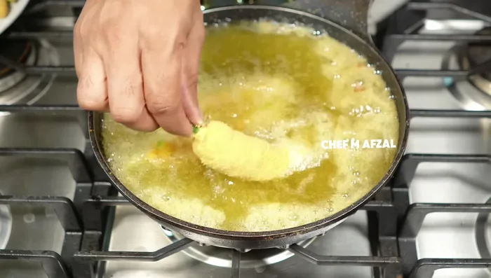 Heat oil in a frying pan. Fry the chilli pakoras in medium-hot oil for 4-5 minutes, or until golden brown and crispy.