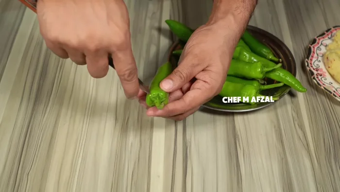 Remove seeds from long green chillies. Wash and set aside.