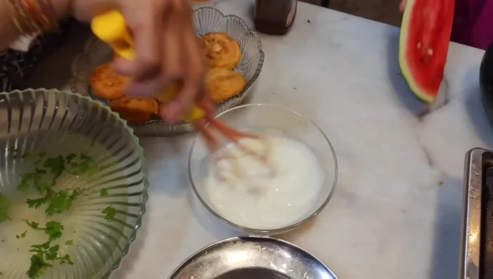 Whisk yogurt with salt and a little water until smooth. Add green coriander.