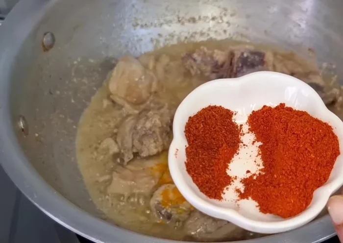 Add turmeric (0.5 tsp), red chili powder (1 tsp), Kashmiri red chili powder (1 tbsp). Fry for 2 minutes.