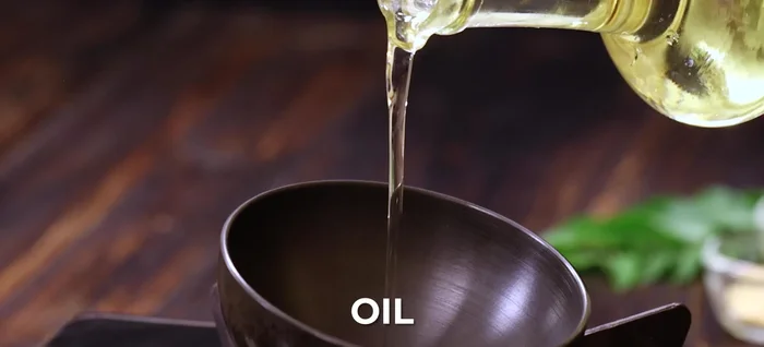 Prepare tempering: Heat oil; add urad dal and mustard seeds until they splutter. Add hing, red chili, and curry leaves. Remove from heat.